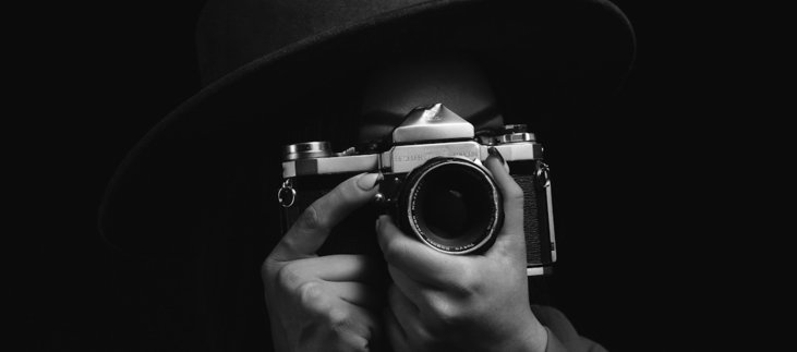 woman holding black and silver camera